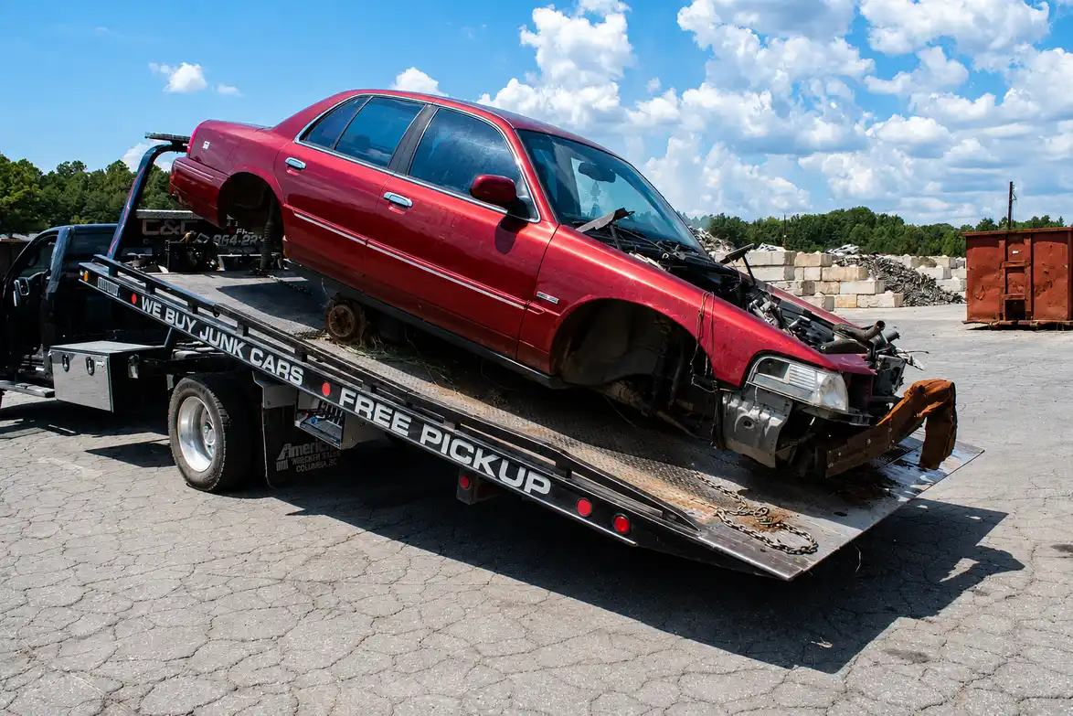 End-of-life vehicle attached to a tow hook for scrap car removal in Brisbane